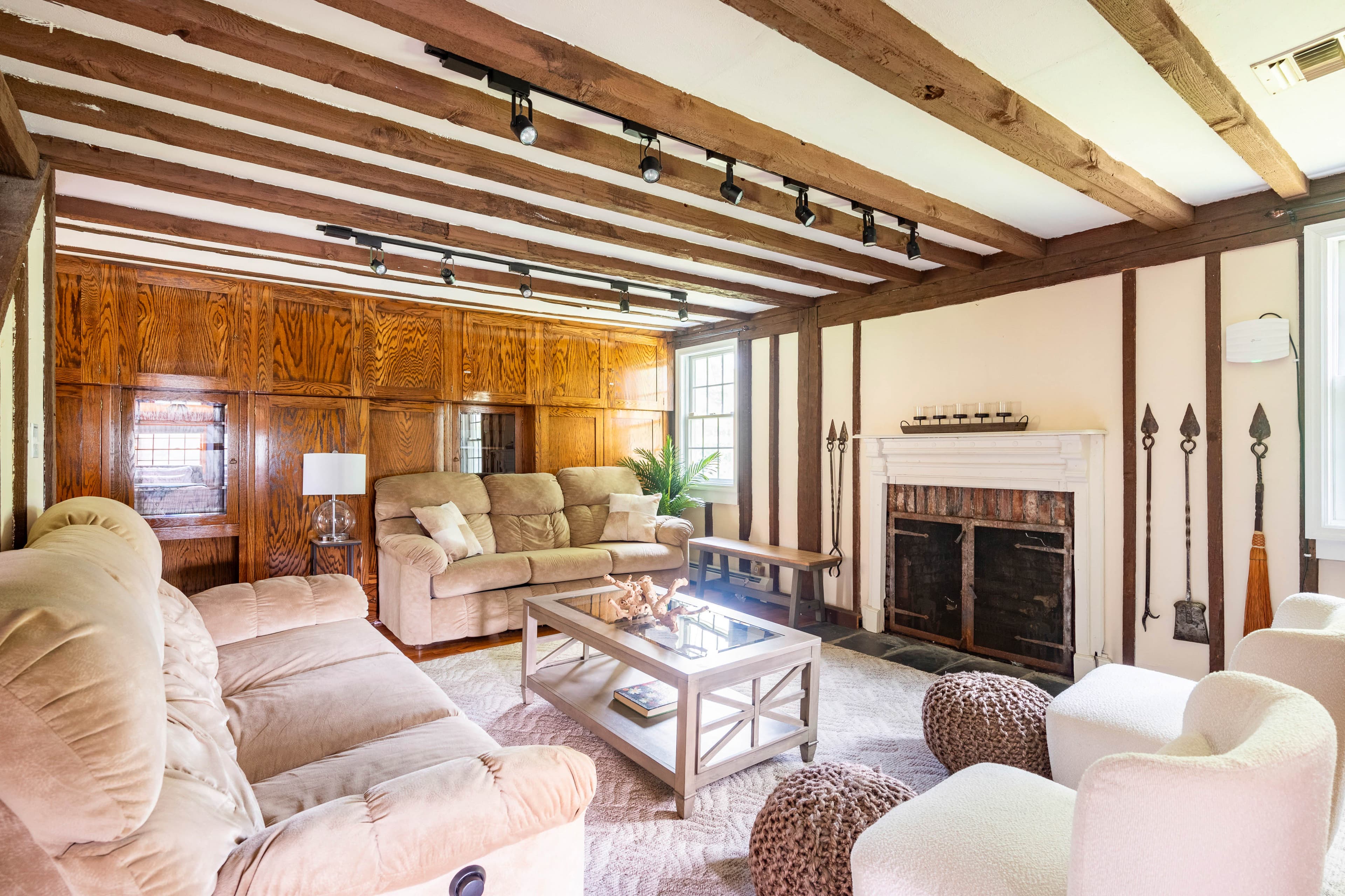 Living room with exposed beams and fireplace